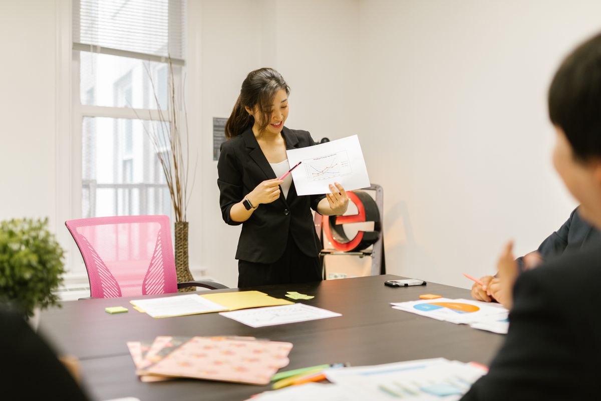 A trainer explaining a chart to a colleague during a workshop session